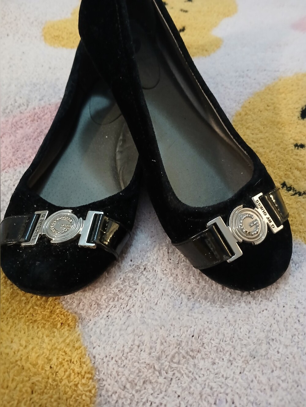 Pre-loved Black Velvet Women's Guess Ballet Flats with Silver Emblem.